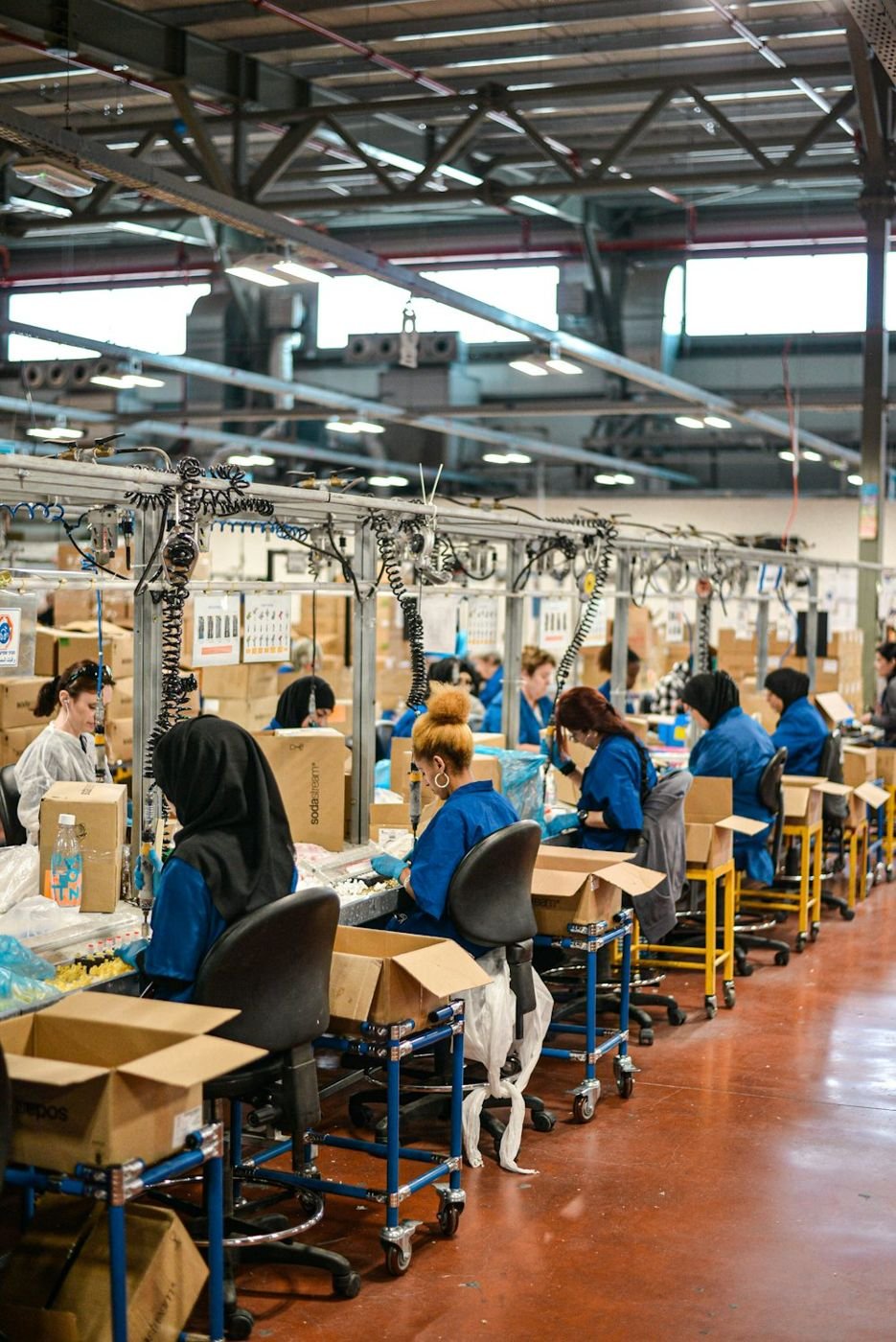 Factory floor with workers and packed goods